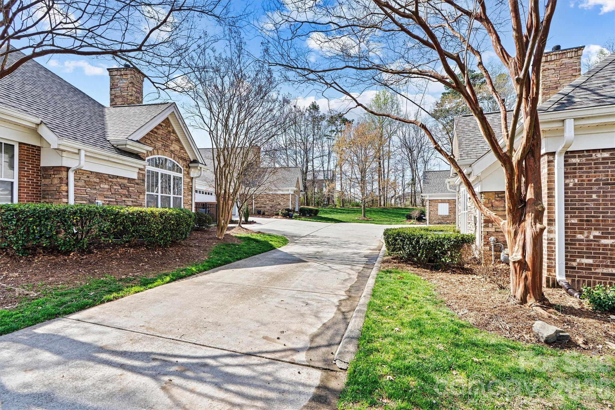 2830 Bellasera Way Matthews, NC 28105 - Photo 3 of 40 a view of a white house with a yard and pathway