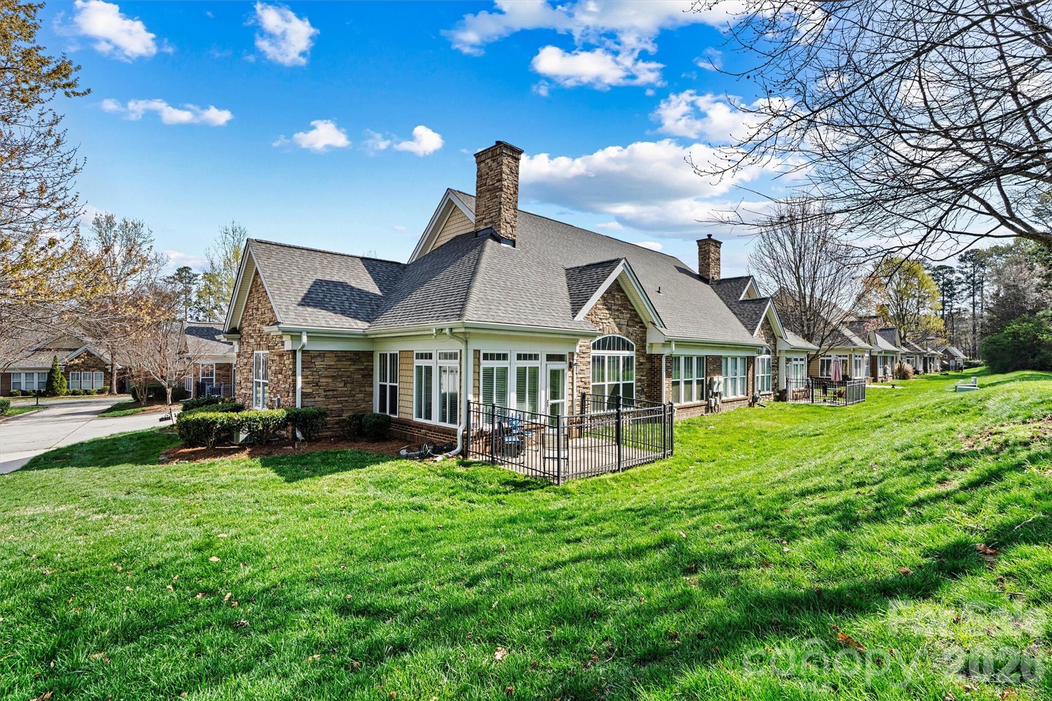 2830 Bellasera Way Matthews, NC 28105 - Photo 32 of 40 a front view of a house with a yard table and chairs
