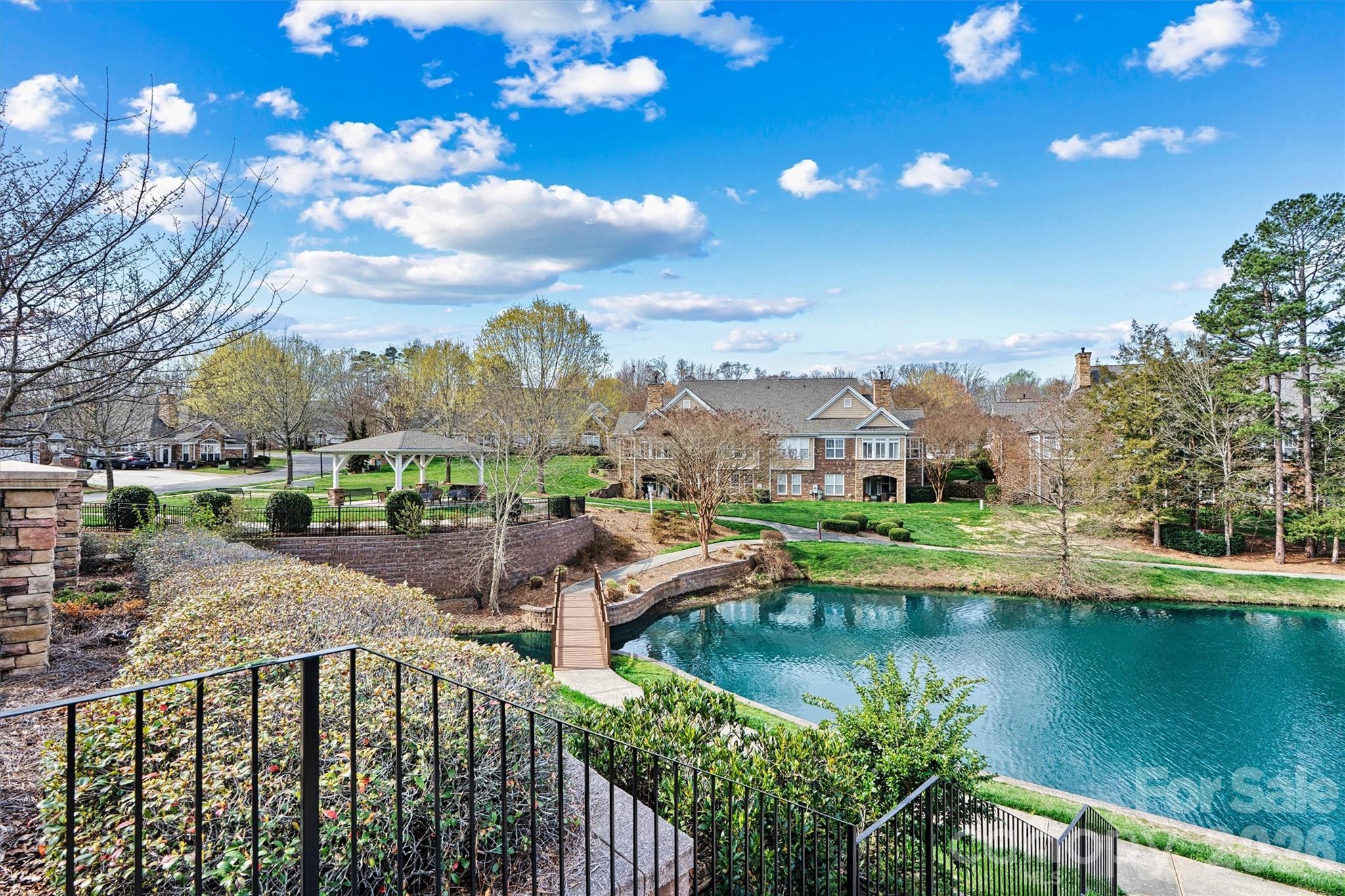 2830 Bellasera Way Matthews, NC 28105 - Photo 38 of 40 a view of a lake with a house in the background