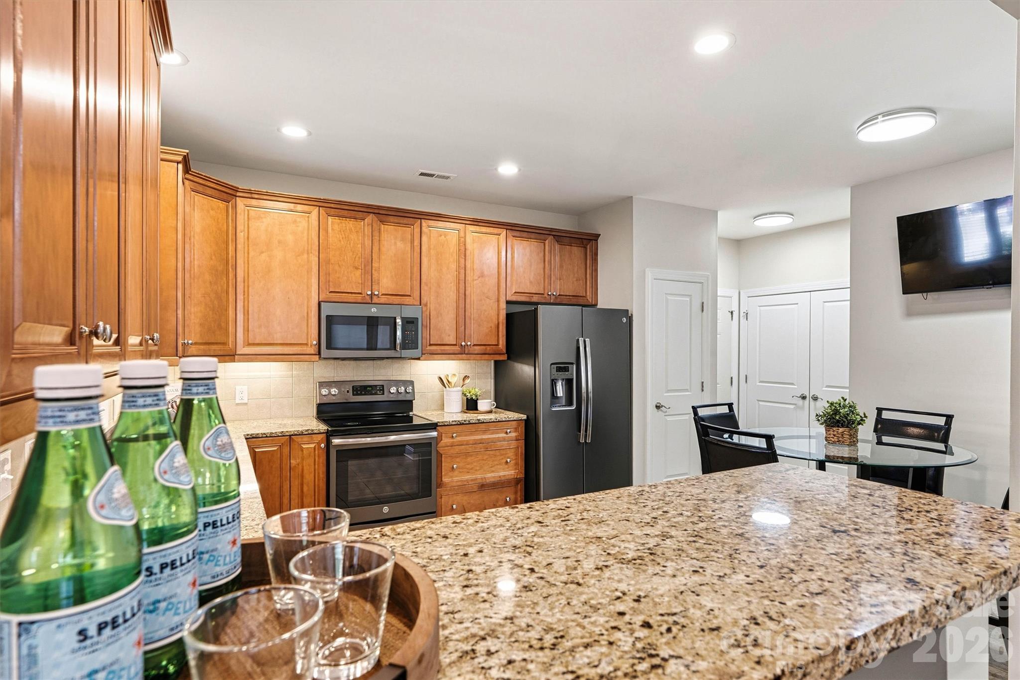 2830 Bellasera Way Matthews, NC 28105 - Photo 10 of 40 a kitchen with stainless steel appliances kitchen island granite countertop a refrigerator stove and sink