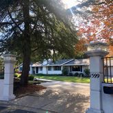 a front view of a house with a garden