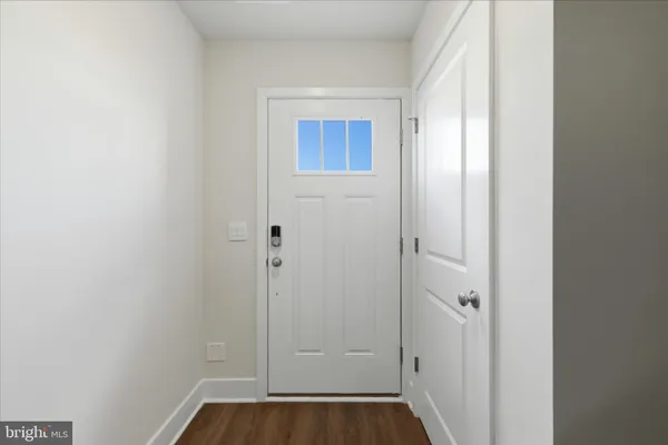 a view of front door with wooden floor