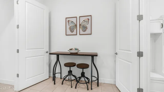 a view of a room with a table and chairs