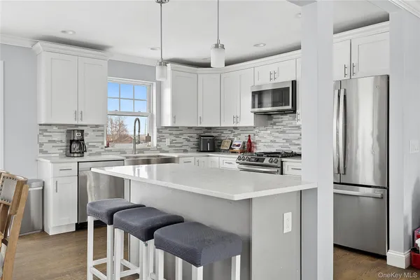 a kitchen with stainless steel appliances a refrigerator stove microwave and cabinets