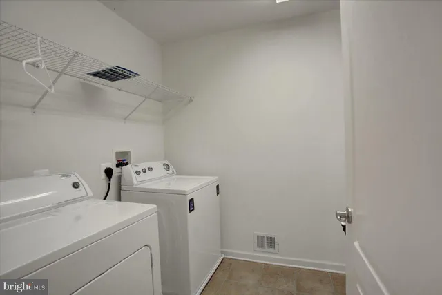 a view of storage and utility room with washer and dryer