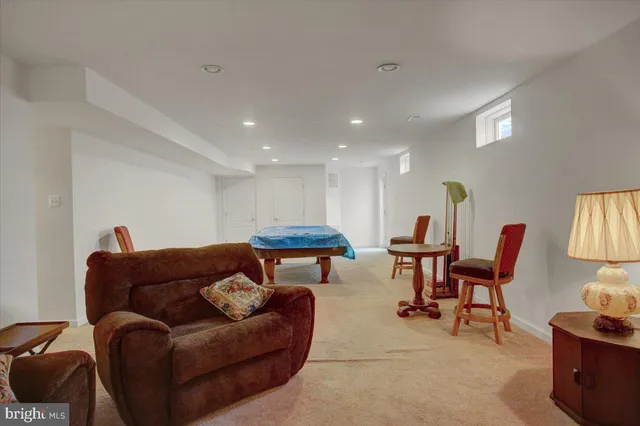 a living room with furniture a kitchen view and a chairs