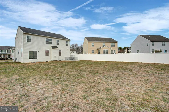 a big house with a big yard and large trees