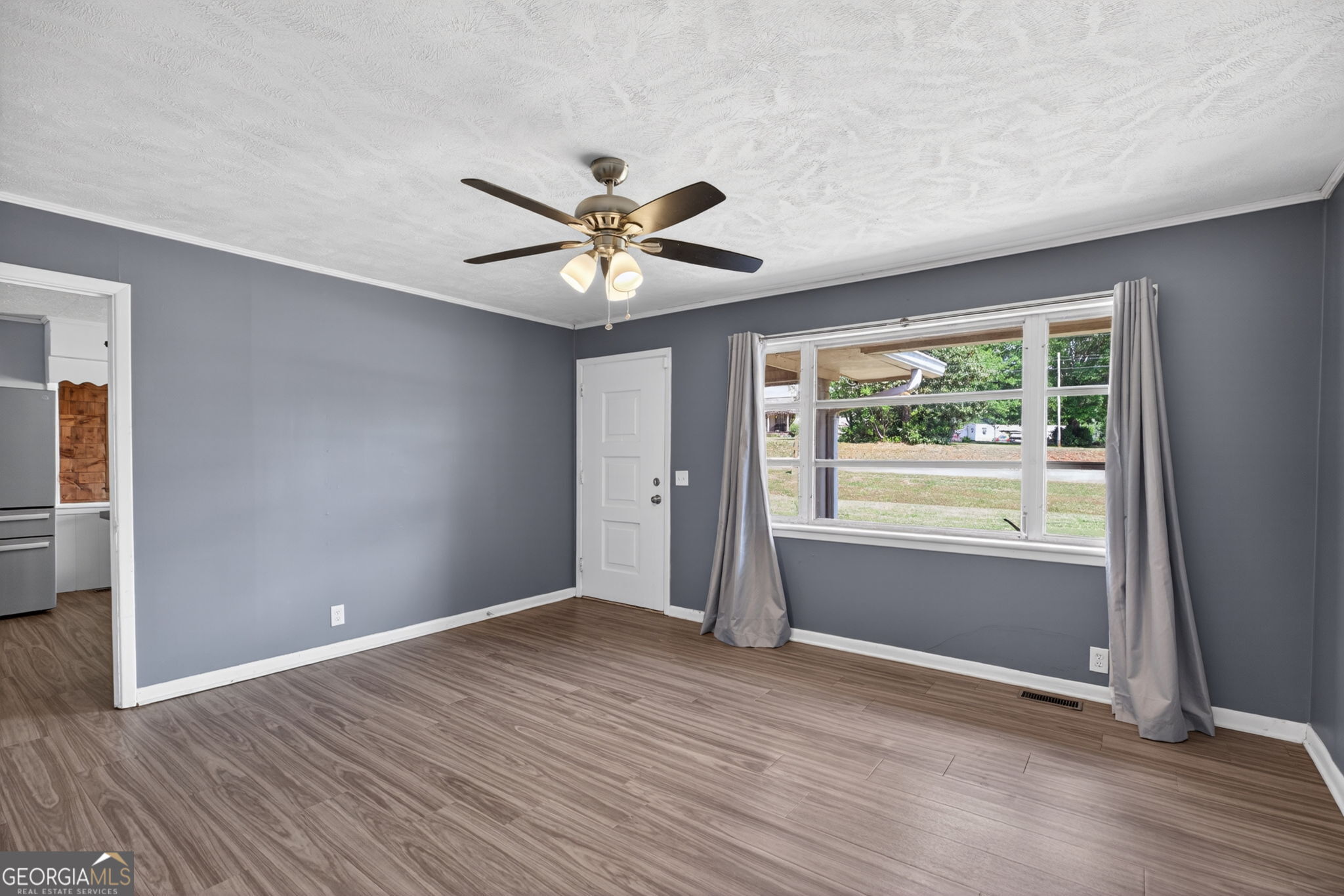 1861 Highway 100 Bowdon, GA 30108 - Photo 11 of 35 an empty room with wooden floor and windows