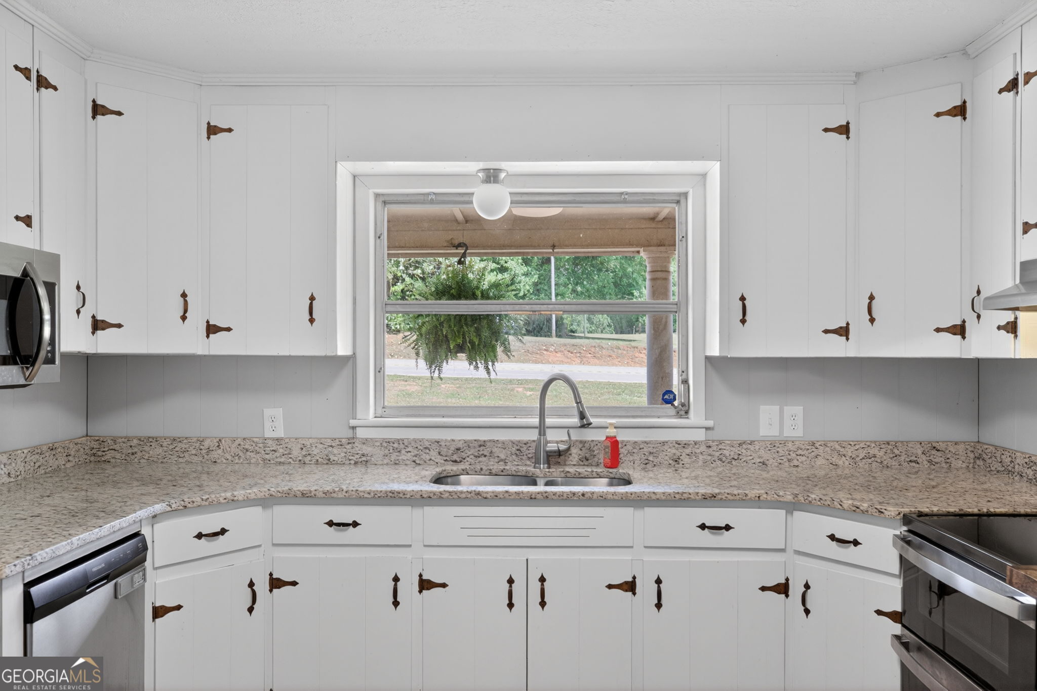 1861 Highway 100 Bowdon, GA 30108 - Photo 13 of 35 a kitchen with granite countertop white cabinets and window