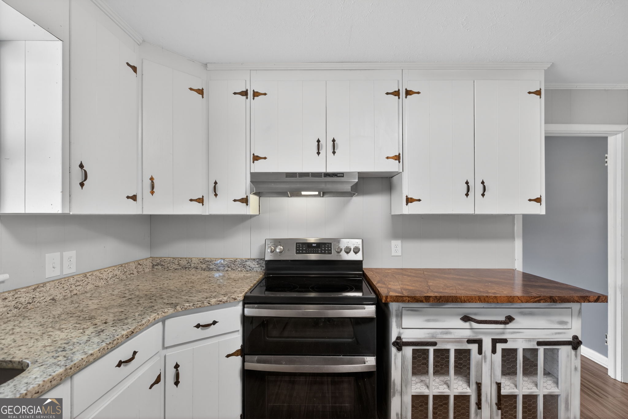 1861 Highway 100 Bowdon, GA 30108 - Photo 15 of 35 a kitchen with granite countertop stainless steel appliances and white cabinets
