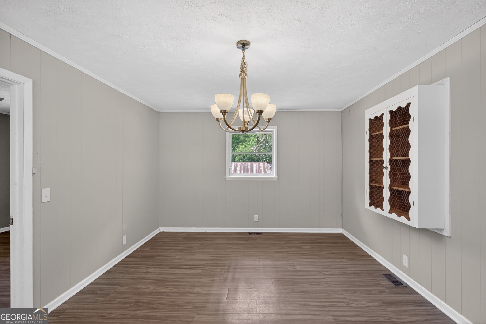 1861 Highway 100 Bowdon, GA 30108 - Photo 16 of 35 a view of an empty room with wooden floor and windows