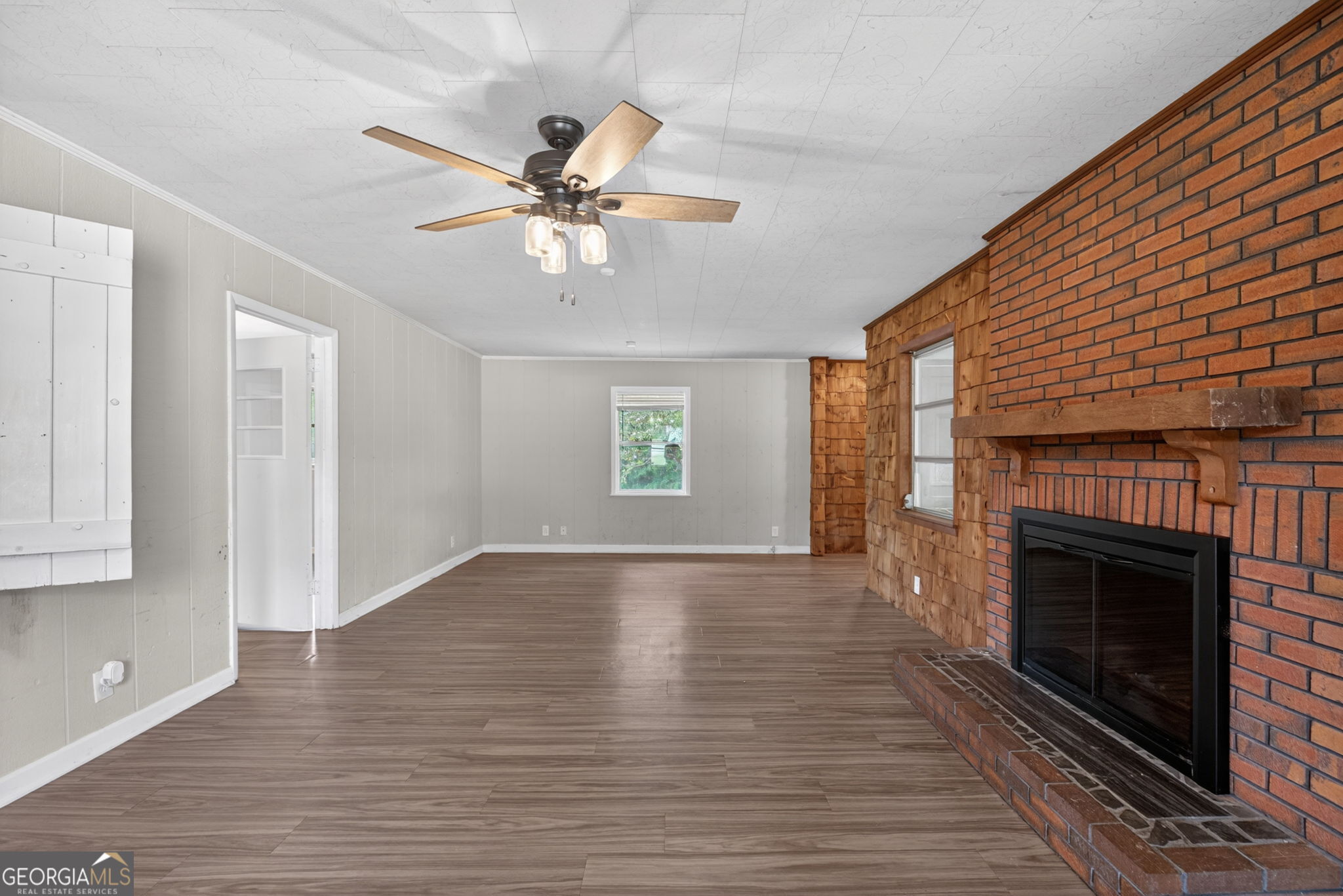 1861 Highway 100 Bowdon, GA 30108 - Photo 20 of 35 a view of an empty room with wooden floor fireplace and a window