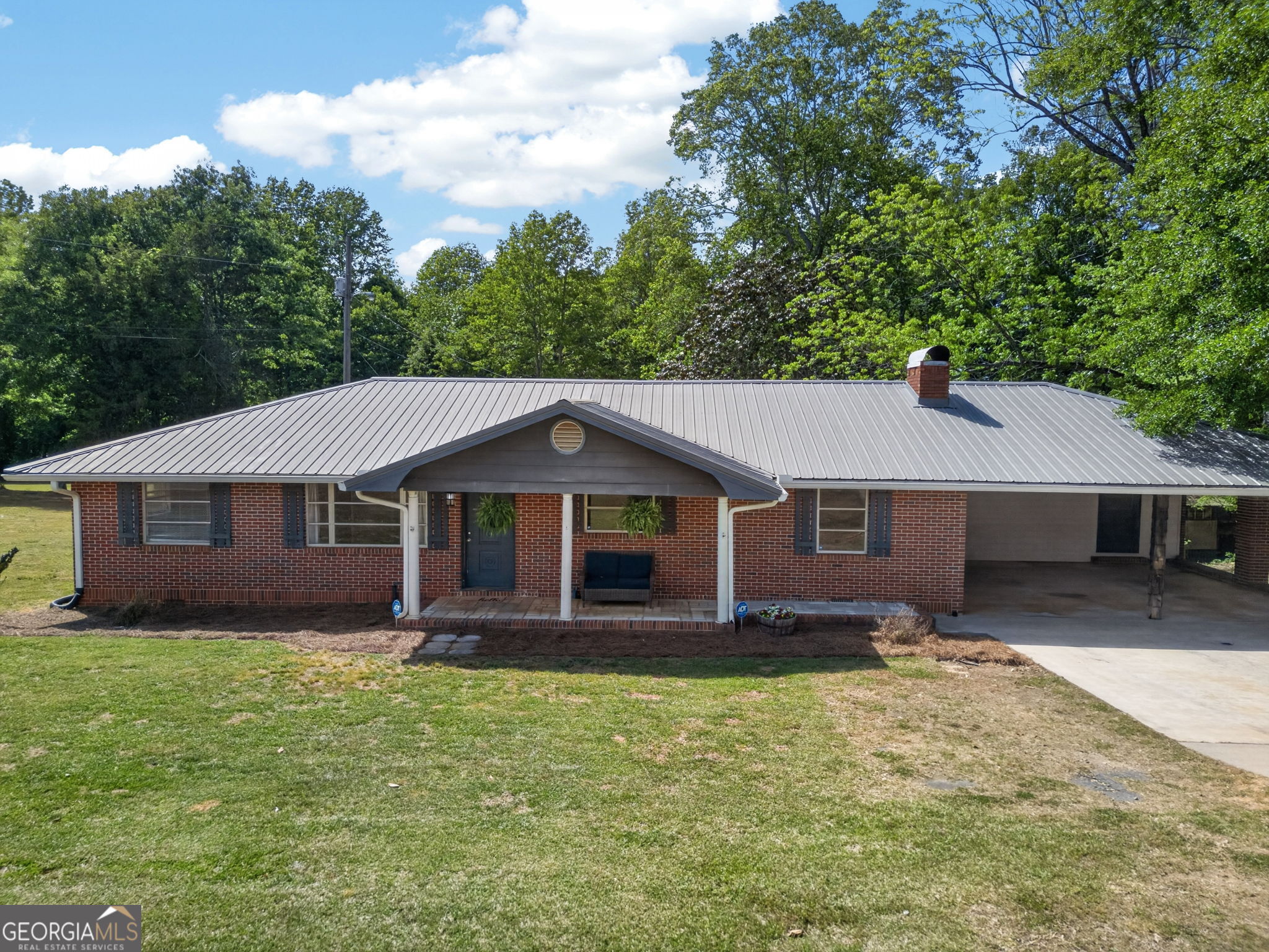 1861 Highway 100 Bowdon, GA 30108 - Photo 2 of 35 a front view of a house with a garden