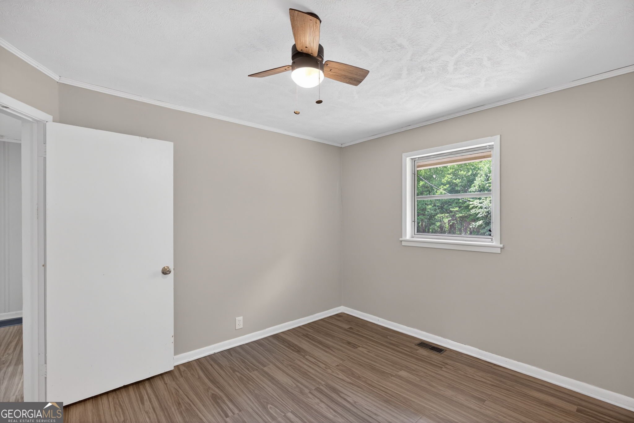 1861 Highway 100 Bowdon, GA 30108 - Photo 22 of 35 a view of an empty room with wooden floor and a window