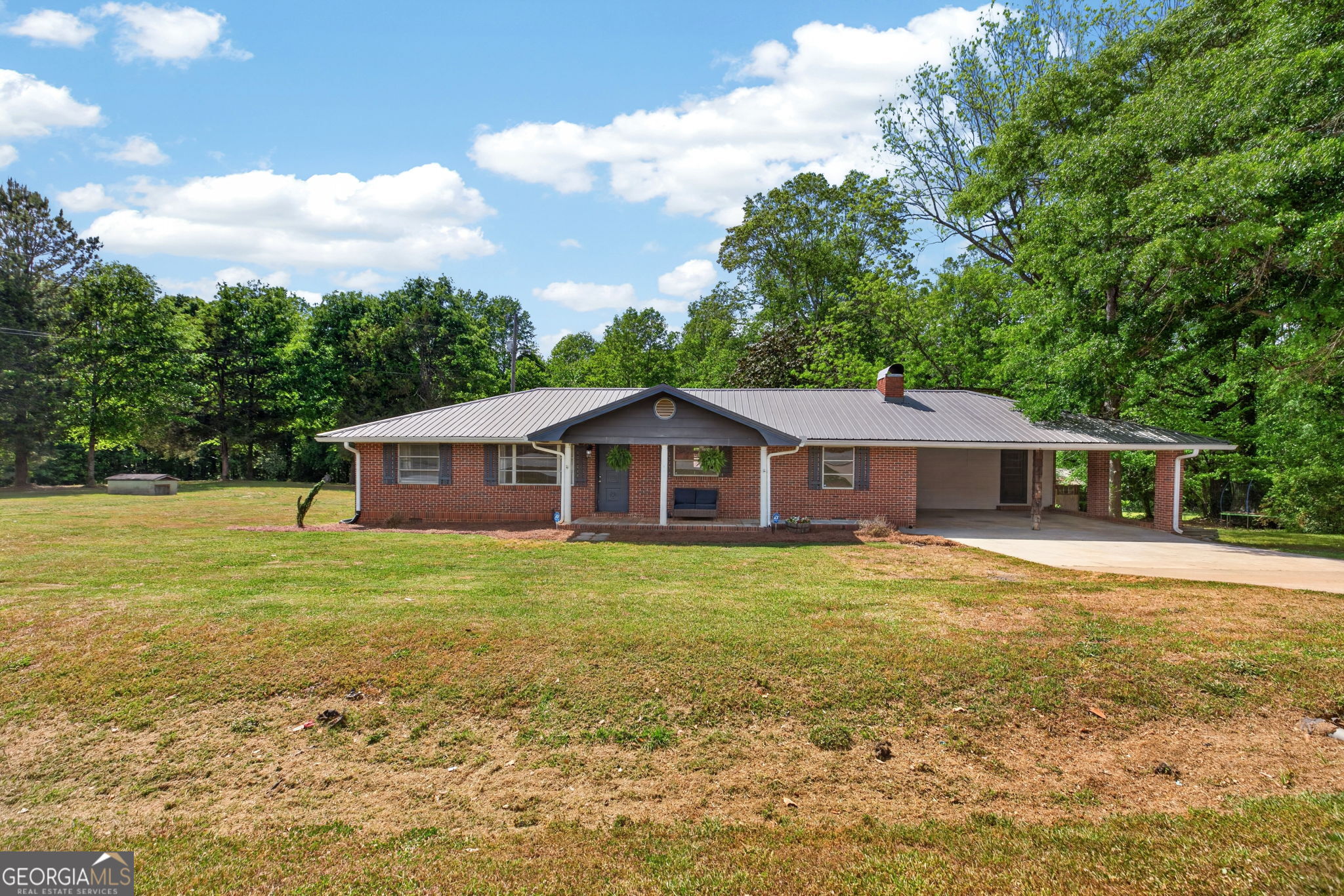 1861 Highway 100 Bowdon, GA 30108 - Photo 4 of 35 a big house with a big yard and large trees