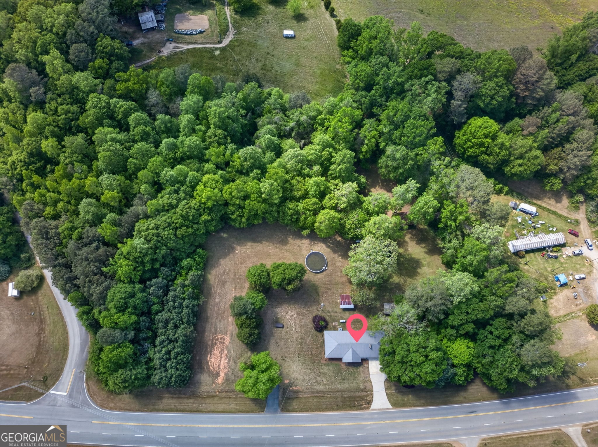 1861 Highway 100 Bowdon, GA 30108 - Photo 7 of 35 an aerial view of a house with a yard and garden