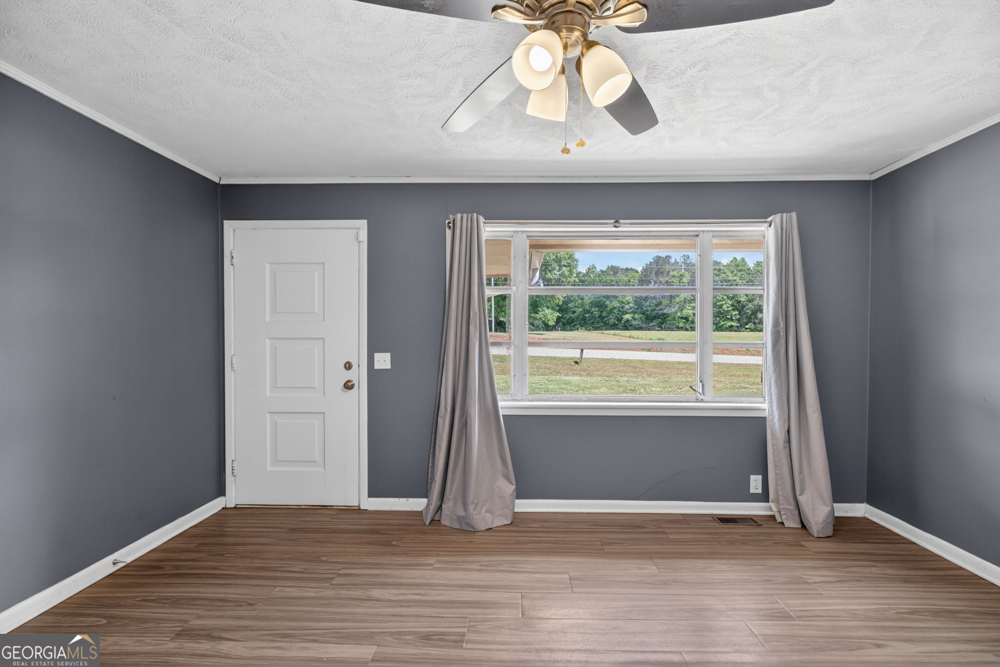 1861 Highway 100 Bowdon, GA 30108 - Photo 10 of 35 an empty room with wooden floor and windows