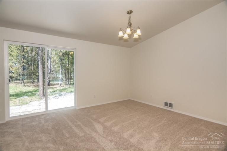 17306 Kingsburg Road Bend, OR 97707 - Photo 18 of 22 wooden floor in an empty room with a window