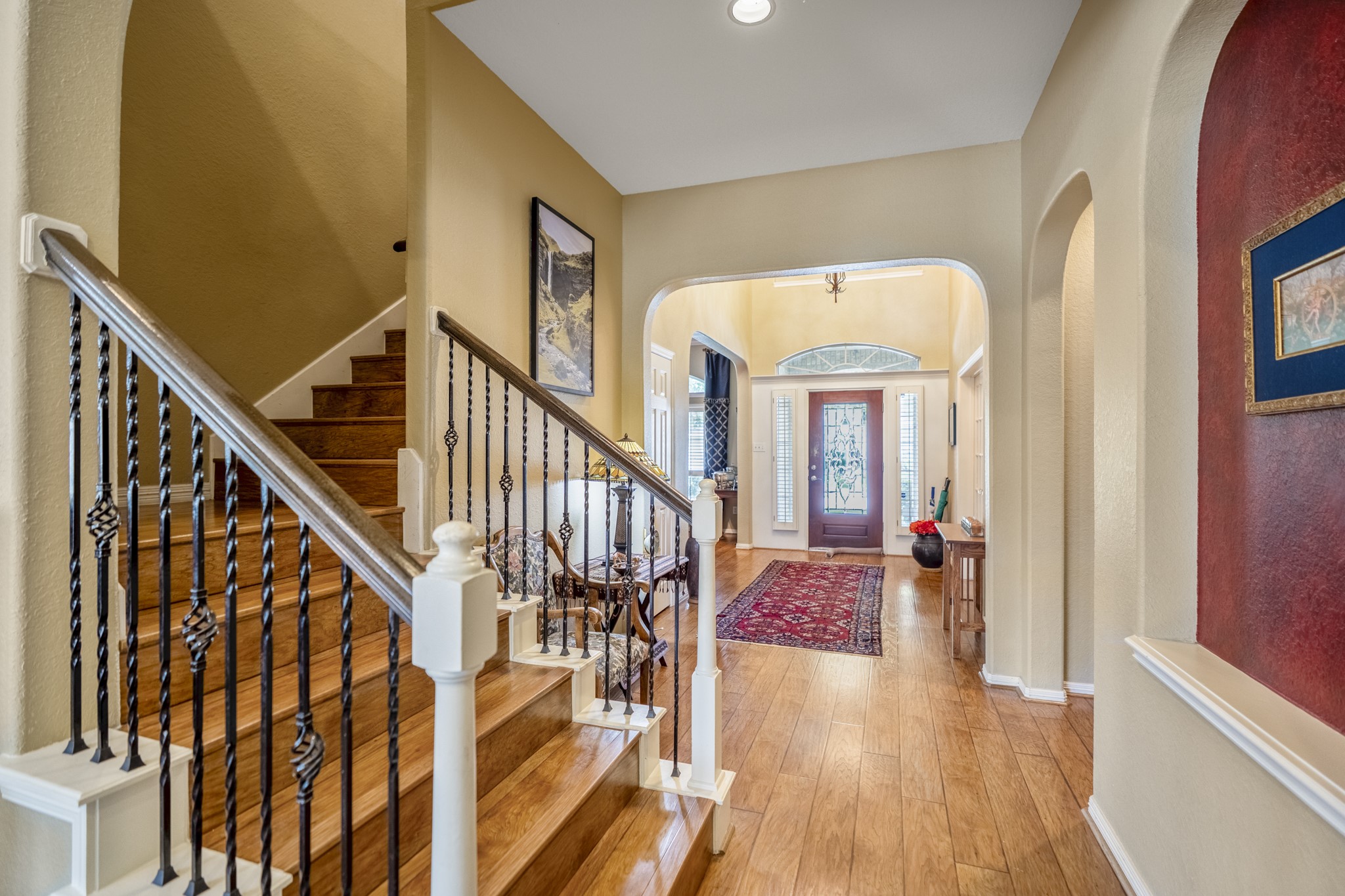 1438 Hatchmere Place Spring, TX 77379 - Photo 7 of 50 Beautiful wood tread stairs and ornate iron spindles on the staircase leading to the second floor living.