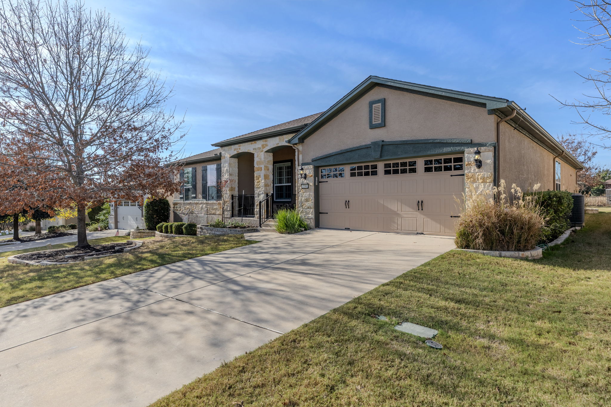 110 Emory Peak Trail Georgetown, TX 78633 - Photo 2 of 39 View of front of home with stone siding, stucco siding, concrete driveway, and a garage