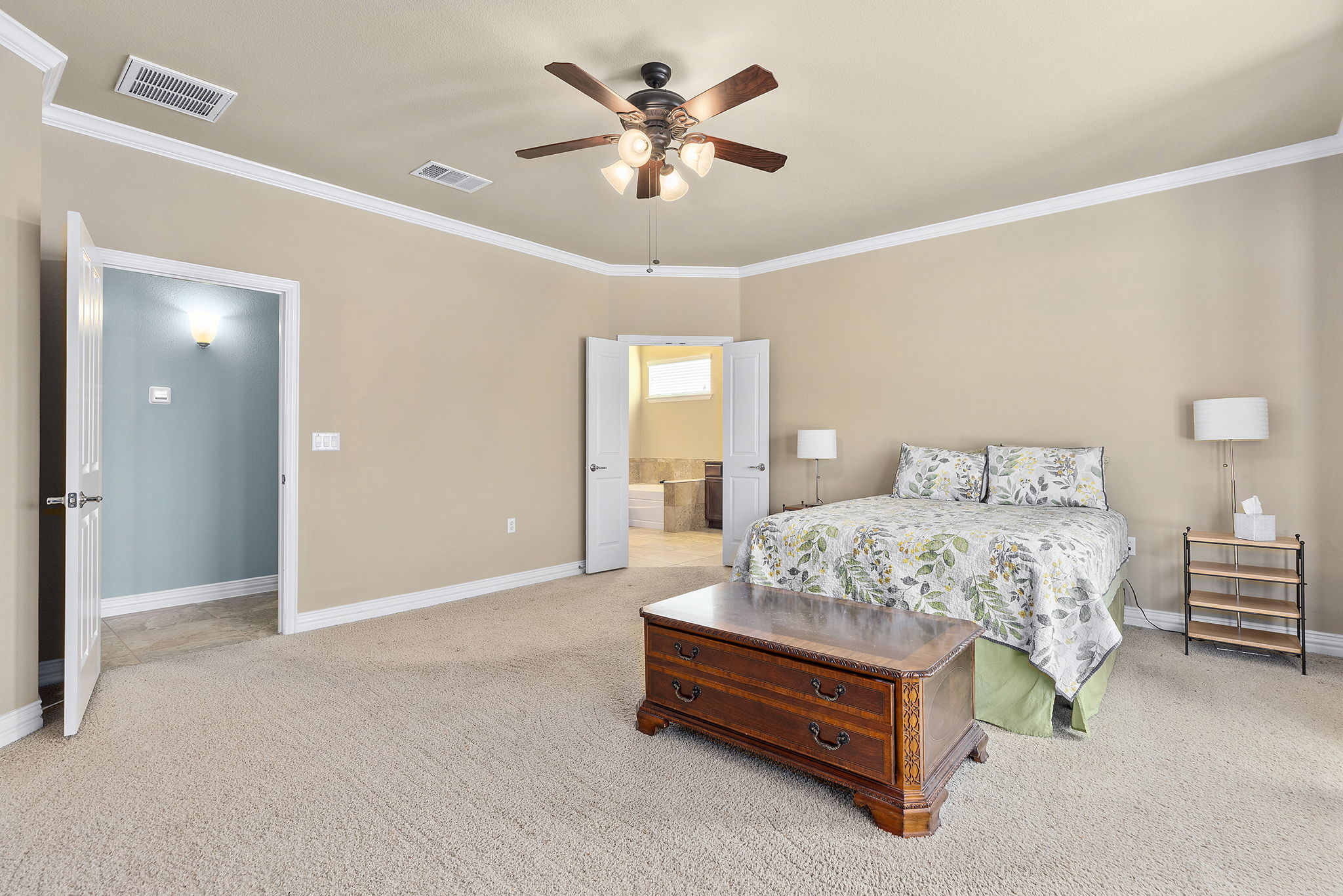 110 Emory Peak Trail Georgetown, TX 78633 - Photo 22 of 39 Carpeted bedroom with ornamental molding, connected bathroom, and a ceiling fan