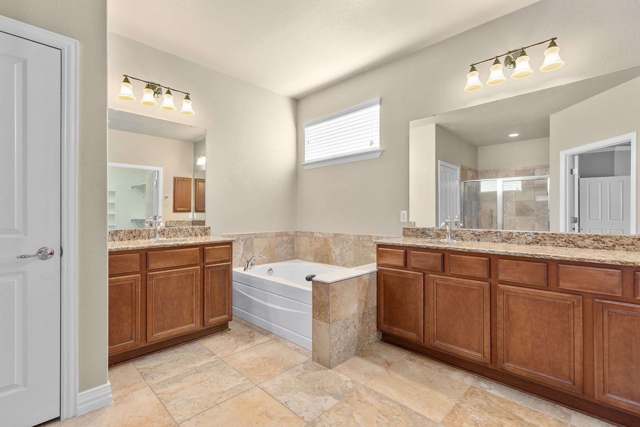 110 Emory Peak Trail Georgetown, TX 78633 - Photo 23 of 39 Full bathroom with a bath, two vanities, and a shower stall