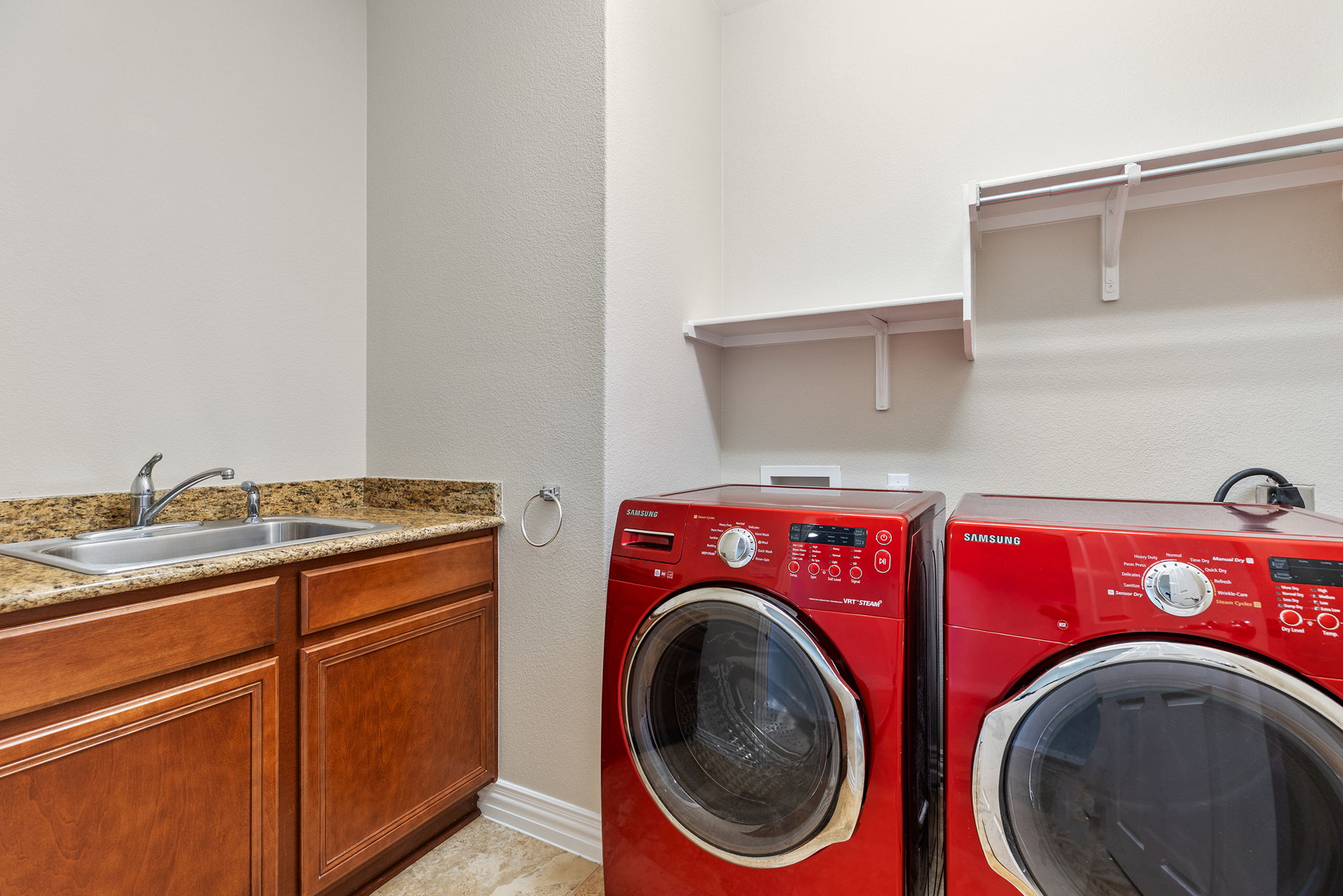 110 Emory Peak Trail Georgetown, TX 78633 - Photo 34 of 39 Laundry area featuring separate washer and dryer and a textured wall