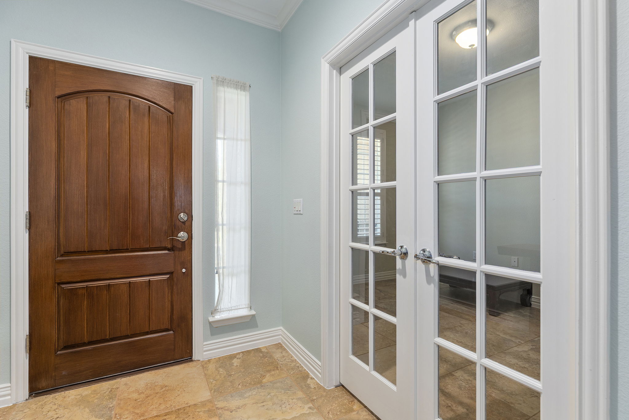 110 Emory Peak Trail Georgetown, TX 78633 - Photo 4 of 39 Foyer featuring french doors, stone finish floors, and ornamental molding