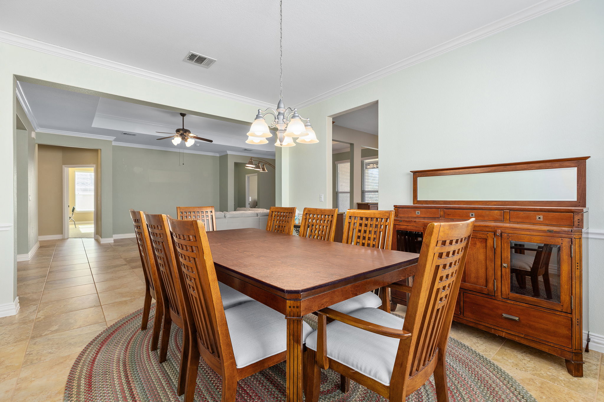 110 Emory Peak Trail Georgetown, TX 78633 - Photo 9 of 39 Dining space with crown molding, a chandelier, ceiling fan, and light tile patterned flooring