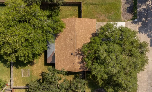 an aerial view of a house with a yard