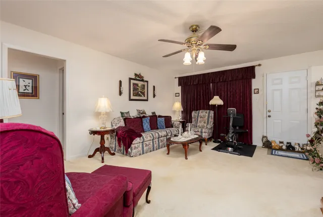 a living room with furniture gym equipment and a chandelier