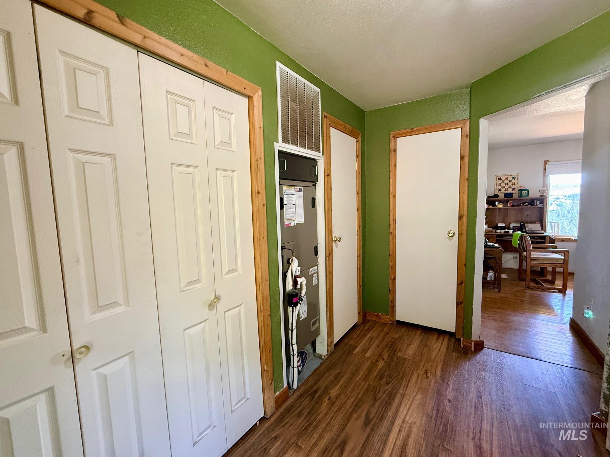 35322 River Road Lenore, ID 83541 - Photo 26 of 42 Interior hallway featuring wood-finish flooring and vibrant green walls