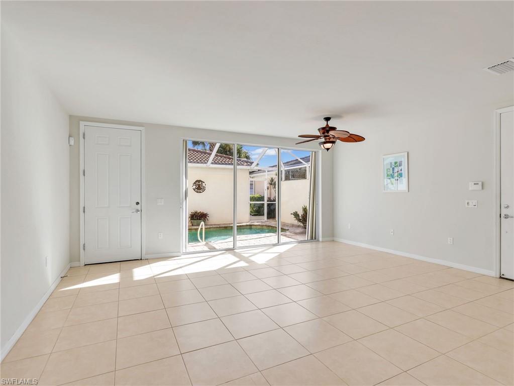 8192 Josefa Way Naples, FL 34114 - Photo 5 of 29 a view of a livingroom with wooden floor and a ceiling fan