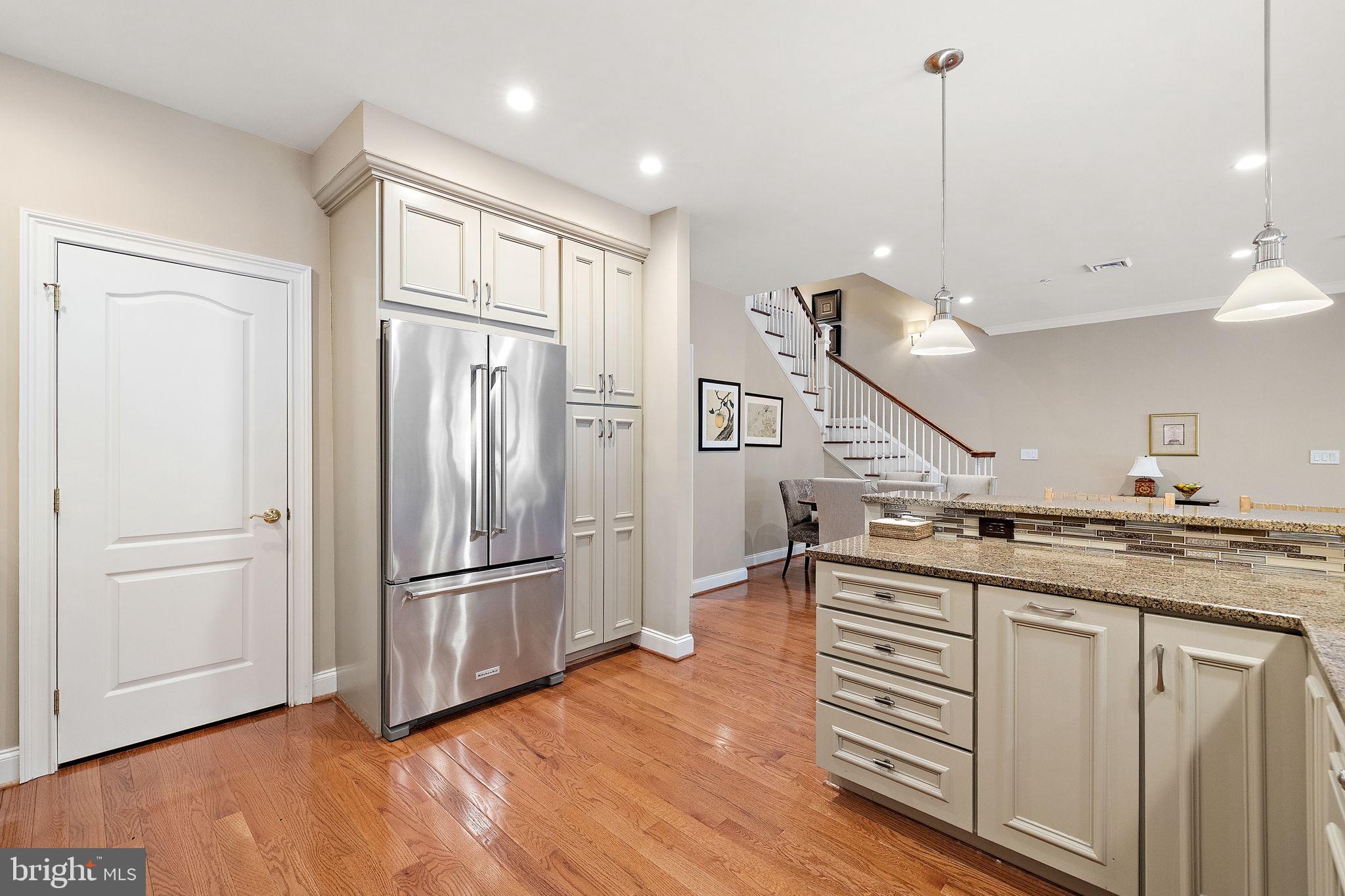 120 Bancroft Mills Road Wilmington, DE 19806 - Photo 11 of 34 a kitchen with stainless steel appliances granite countertop a refrigerator a sink and a wooden floors