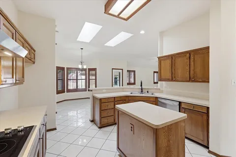 a kitchen with a sink refrigerator and microwave