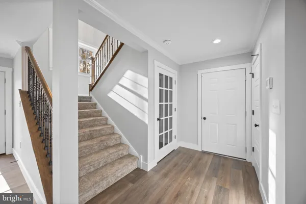 a view of a hallway with wooden floor and entryway