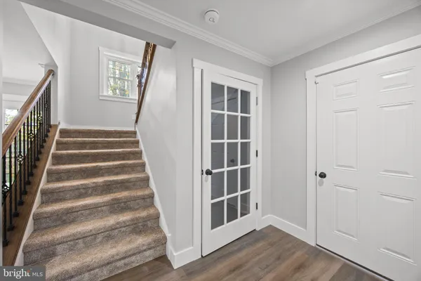 a view of staircase with wooden floor and windows