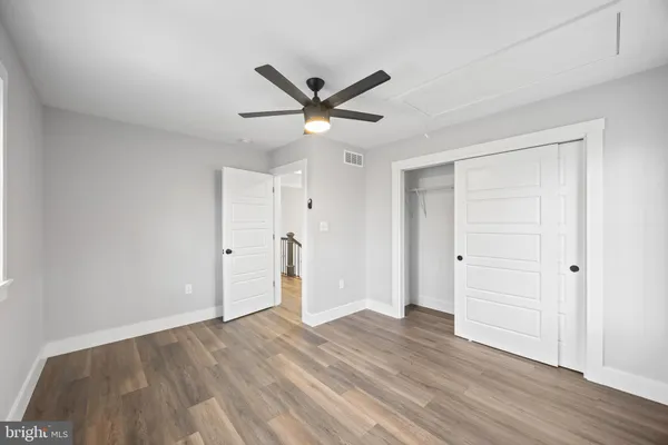 a view of an empty room with wooden floor