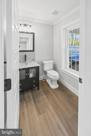 a spacious bathroom with a toilet sink and mirror