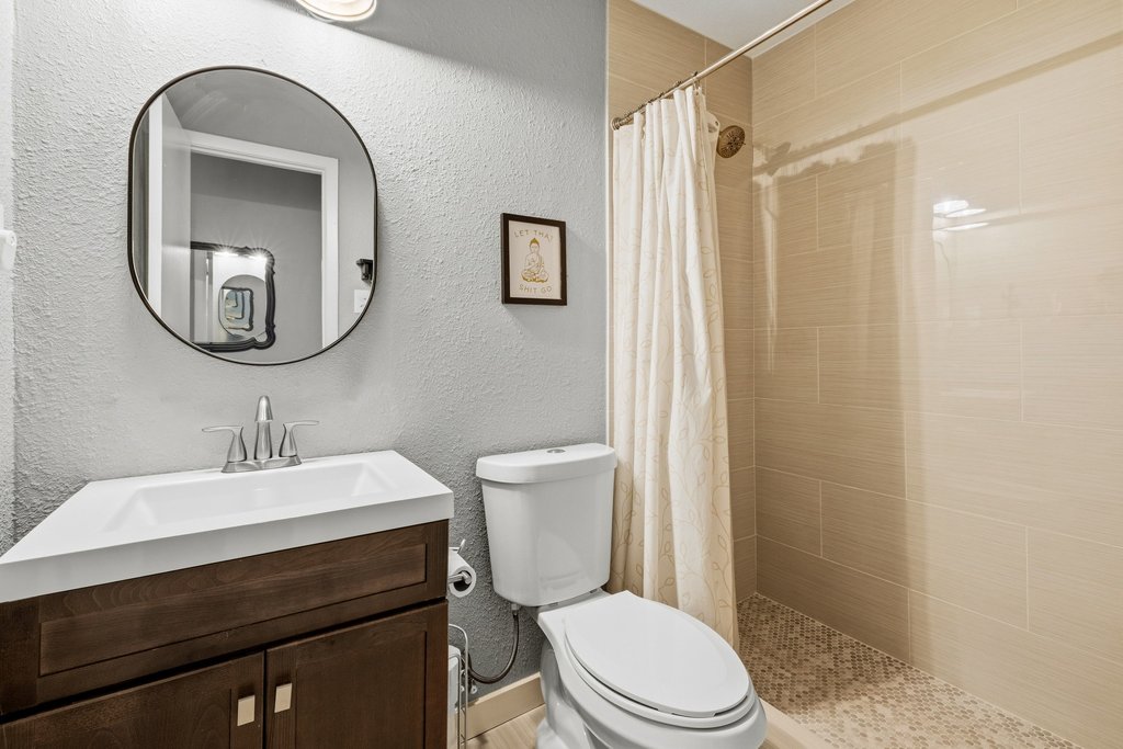 658 Mairo Street Austin, TX 78748 - Photo 29 of 40 A corner vanity and shower with sleek, large-format tile walls define this functional bathroom.