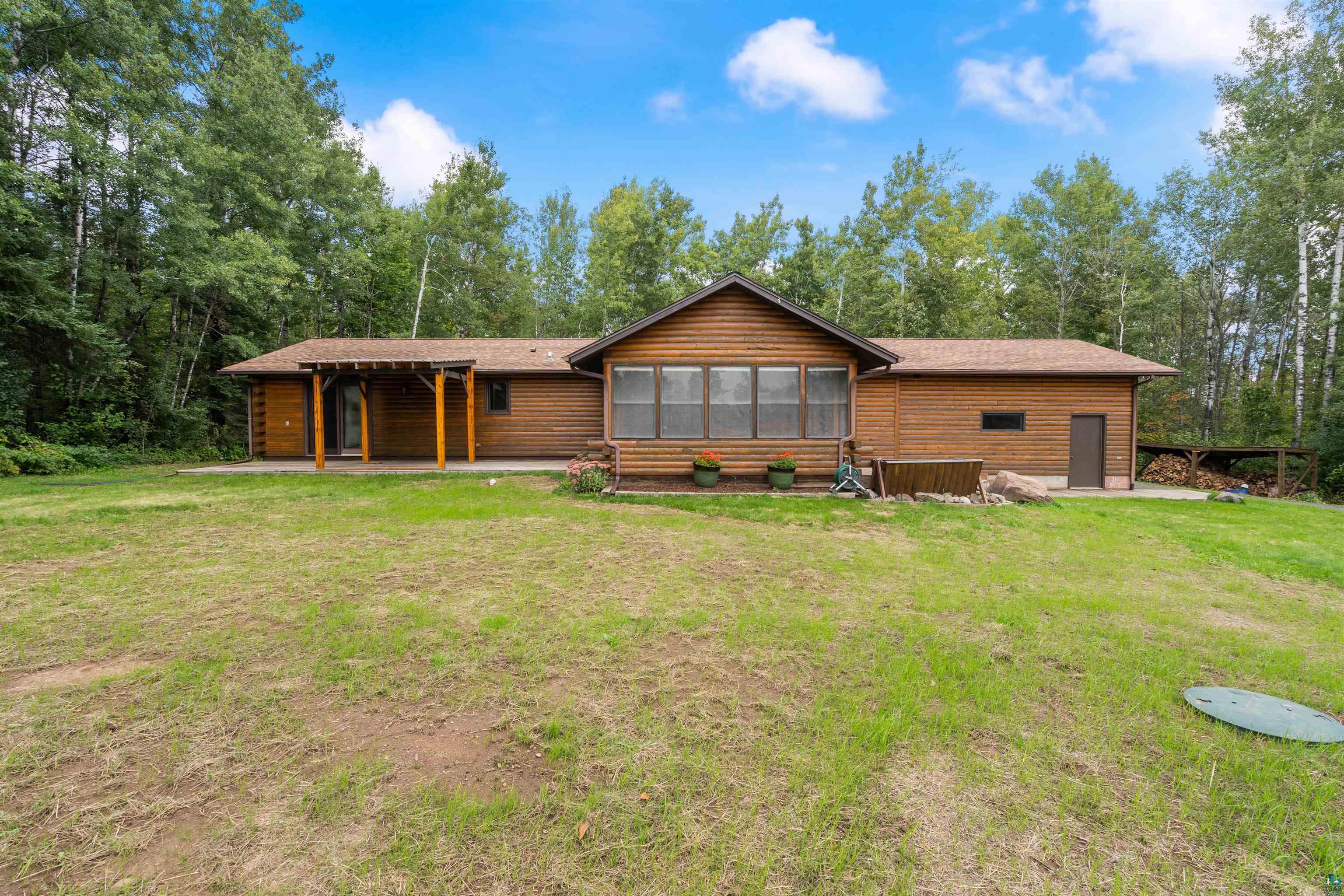 5373 Lester River Road Duluth, MN 55804 - Photo 3 of 39 Wood-sided exterior with a covered patio, multiple windows, and a side entry