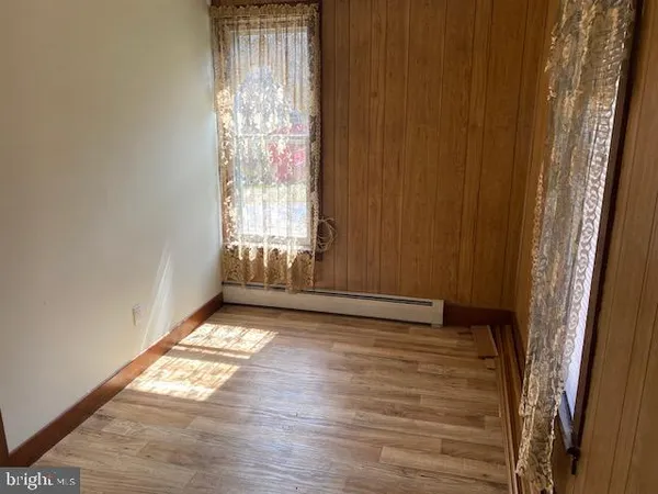 a white toilet sitting next to a shower curtain