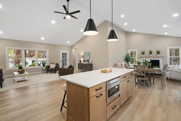 a large kitchen with cabinets a sink a counter space and stainless steel appliances