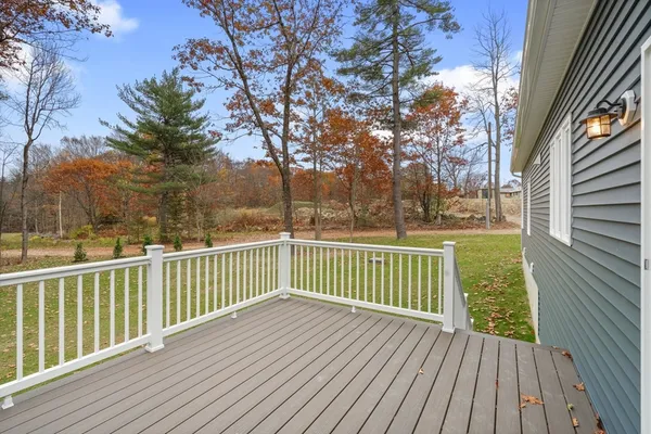 a view of deck with wooden floor and fence with a trees