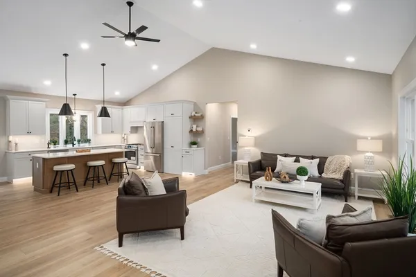 a living room with furniture and kitchen view