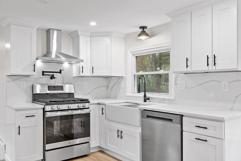 31 Pine Hill Road Chelmsford, MA 01824 - Photo 1 of 42 a kitchen with white cabinets appliances and a window