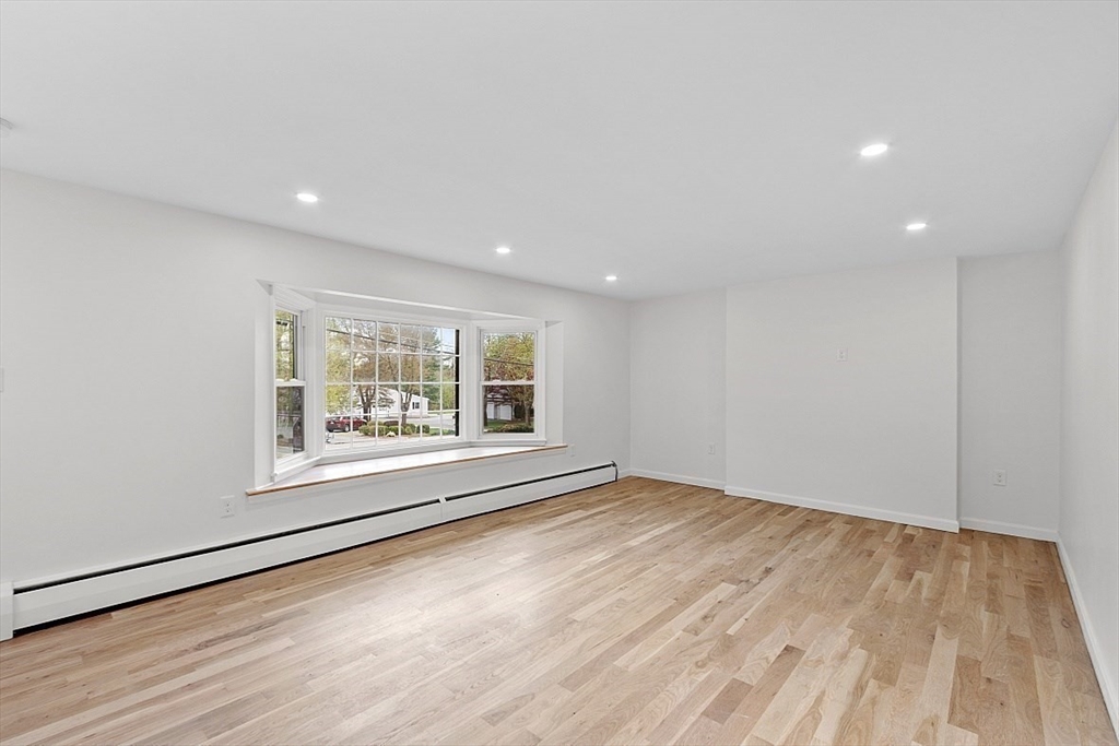 31 Pine Hill Road Chelmsford, MA 01824 - Photo 12 of 42 an empty room with wooden floor and windows