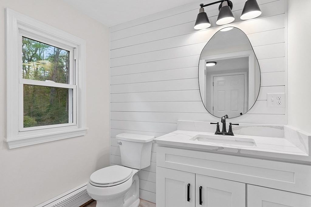 31 Pine Hill Road Chelmsford, MA 01824 - Photo 13 of 42 a bathroom with a toilet a sink and a mirror