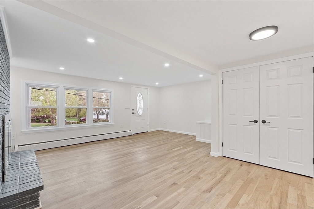 31 Pine Hill Road Chelmsford, MA 01824 - Photo 14 of 42 a view of an empty room with a window and wooden floor