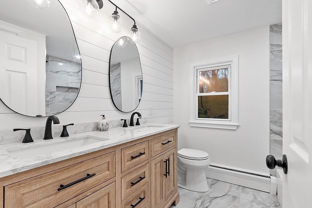 31 Pine Hill Road Chelmsford, MA 01824 - Photo 17 of 42 a bathroom with a double vanity sink toilet and a mirror